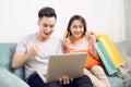 Young asian couple surfing on internet and shopping with laptop. Royalty Free Stock Photo