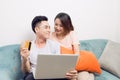 Young asian couple surfing on internet and shopping with laptop. Royalty Free Stock Photo