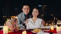 Young asian couple take photo for memory of happiness moment at romantic dinner in rooftop restaurant at city night with sweet Royalty Free Stock Photo