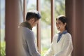 Young asian couple talking chatting outdoors in city park Royalty Free Stock Photo