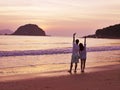 Young asian couple waiting for sunrise on beach Royalty Free Stock Photo