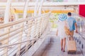 Young asian couple are walking in city. A man carry woman.