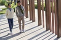 Young asian couple walking outdoors in city park Royalty Free Stock Photo