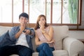 Young asian couple watching horror movie with relax and enjoy holding remote control tv at home Royalty Free Stock Photo