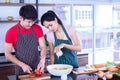 Young, Asian Couples  in apron, make cooking salad for food together Royalty Free Stock Photo