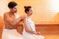 Young Asian couples have romantic relaxing massage in sauna room. Skin care heat treatment and body clean up and refreshing in spa Royalty Free Stock Photo