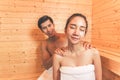 Young Asian couples or lovers have romantic relaxing in sauna room. Skin care heat treatment and body clean up and refreshing in Royalty Free Stock Photo