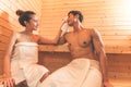 Young Asian couples or lovers have romantic relaxing in sauna room. Skin care heat treatment and body clean up and refreshing in Royalty Free Stock Photo