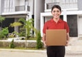 Young asian courier woman delivering package