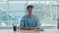 Young Asian creative man smiling in office. Business male happy relax after work, looking to camera, business situation in modern Royalty Free Stock Photo