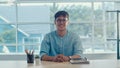Young Asian creative man smiling in office. Business male happy relax after work, looking to camera, business situation in modern Royalty Free Stock Photo