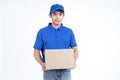 Young Asian delivery man in blue uniform standing with parcel post box isolated over white background.Delivery Service and Onlines