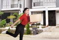 Young asian delivery woman delivering package