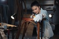 Young Asian designer furniture woman Carpenter uses a tape measure to measure chair