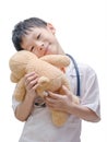 Young Asian doctor boy playing and curing bear toy