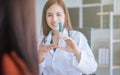 Young asian doctor showing hand press syringe ready to inject shot Vaccination and medical injection image.Healthcare, Medical