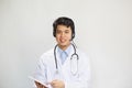 Young asian doctor with stethoscope talking with patient