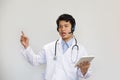 Young asian doctor with stethoscope talking with patient