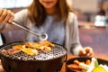 Young asian eating korean barbecue yakiniku