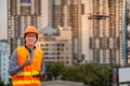 Young Asian engineer flying drone over construction site