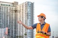 Young Asian engineer flying drone over construction site