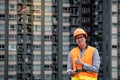 Young Asian engineer flying drone over construction site