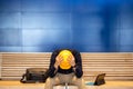 Young Asian engineer man feeling tried while sitting on bench Royalty Free Stock Photo