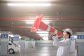 Young Asian engineer yelling though traffic safety cone in parking lot Royalty Free Stock Photo