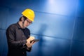 Young Asian engineer man writing on tablet Royalty Free Stock Photo