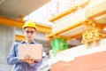 Young asian engineers are working on the construction site. Wear a yellow helmet safety and uniform staff. Hand holding smart Royalty Free Stock Photo