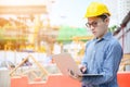 Young asian engineers are working on the construction site. Wear a yellow helmet safety Royalty Free Stock Photo