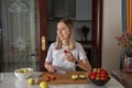 Young caucasian woman cooking fresh fruit and vegetable salad on table. Person preparing healthy yummy eating lunch in Royalty Free Stock Photo