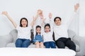 Young asian family entertained at home in free time