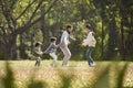 Asian family enjoying outdoor activity in city park Royalty Free Stock Photo