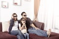 Young asian family wearing 3D glasses watching TV