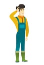 Young asian farmer in coveralls laughing.