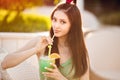 Young asian fashion woman drinking cocktail in a beach bar. Royalty Free Stock Photo