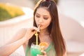 Young asian fashion woman drinking cocktail in a beach bar. Royalty Free Stock Photo