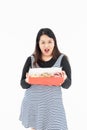 A young Asian fat woman has a donut in her hand Royalty Free Stock Photo