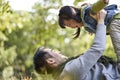 Young asian father and daughter having a good time outdoors in park Royalty Free Stock Photo