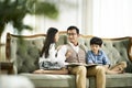 Asian father and two children reading book together Royalty Free Stock Photo