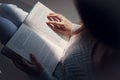 Young asian female college student sitting on floor in library, reading book Royalty Free Stock Photo