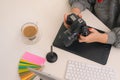 Young asian female designer using graphics tablet while working with computer at studio or office Royalty Free Stock Photo