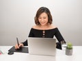 Young Asian female designer using graphics tablet while working with computer Royalty Free Stock Photo