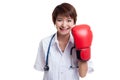 Young Asian female doctor with boxing glove. Royalty Free Stock Photo