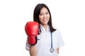 Young Asian female doctor with boxing glove. Royalty Free Stock Photo