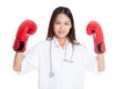 Young Asian female doctor guard with boxing glove Royalty Free Stock Photo