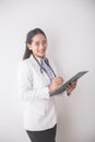 Young asian Female doctor, holding a clipboard and smiling to ca Royalty Free Stock Photo