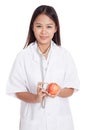 Young Asian female doctor listening to an apple with a stethoscope Royalty Free Stock Photo