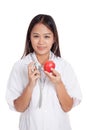 Young Asian female doctor listening to an apple with a stethoscope Royalty Free Stock Photo